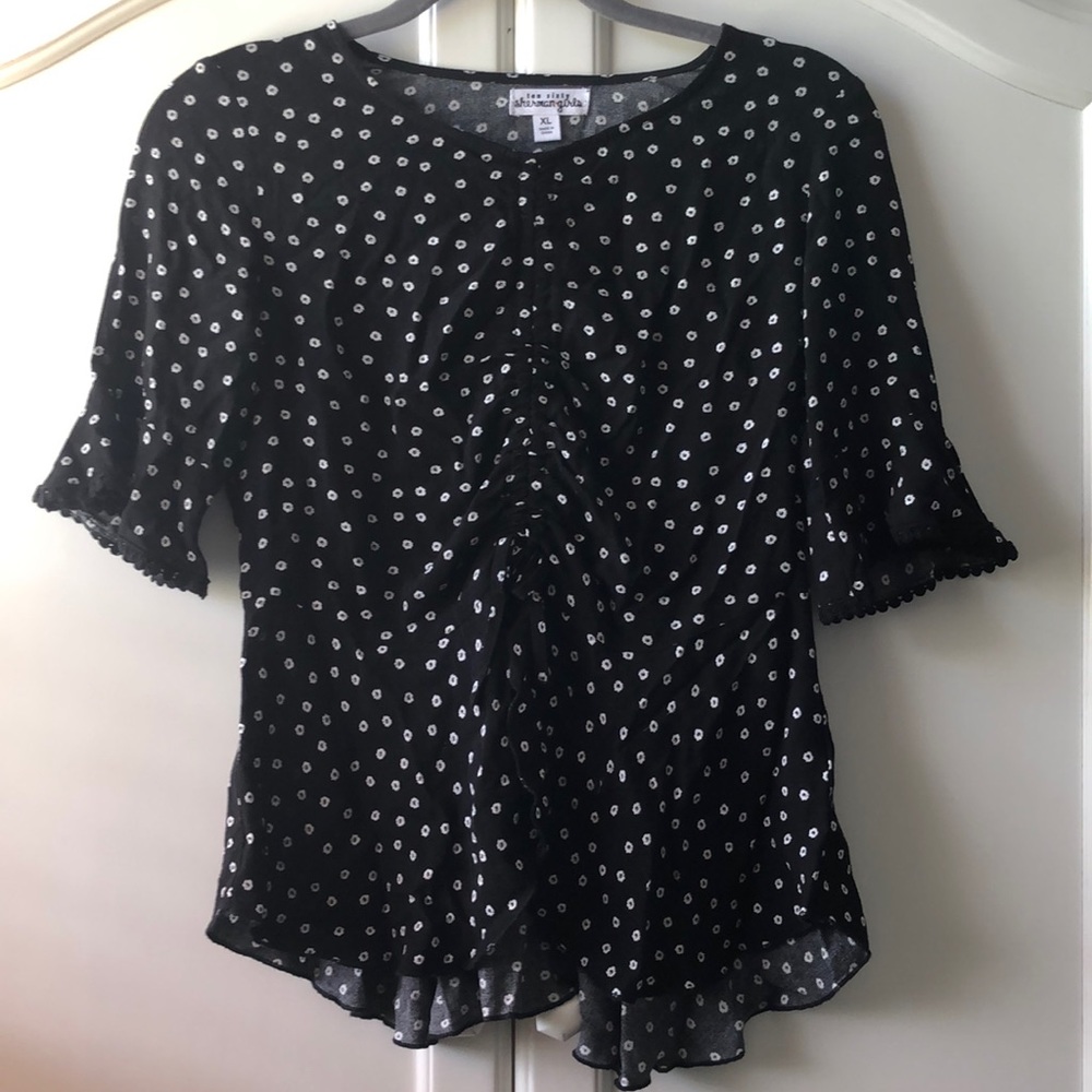 White Daisy on Black Blouse